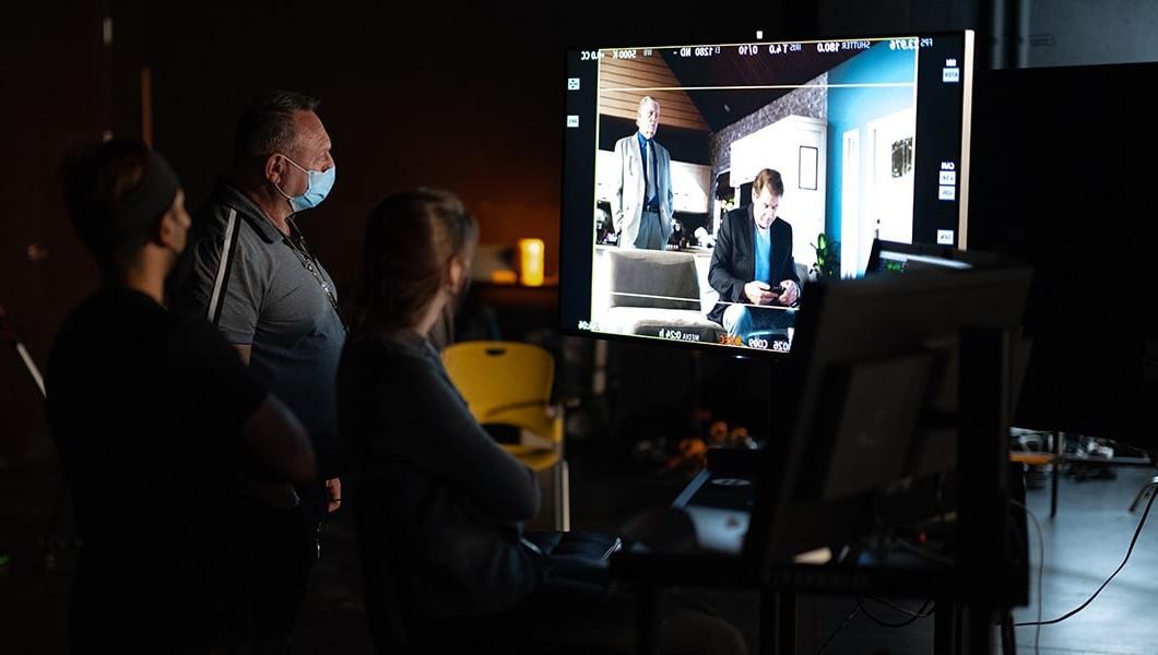 Crew members work in front of a computer displaying the Unreal Engine view of the '9 Windows' set.